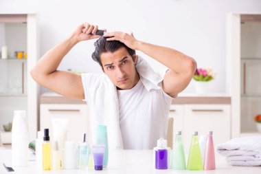 Tuvaletteki genç yakışıklı adam hijyen konseptinde. 