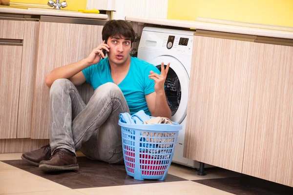 Young husband man doing laundry at home Royalty Free Stock Photos