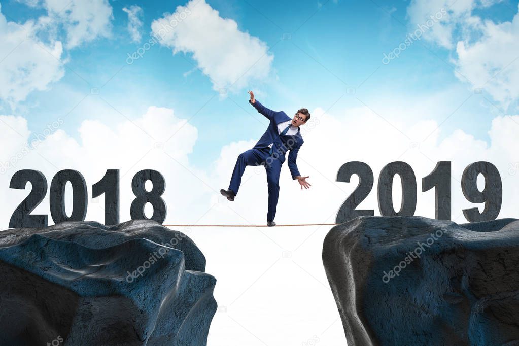 Businessman balancing between 2018 and 2018