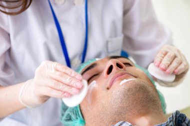 Genç adam, kadın doktor kozmetikçisini ziyaret ediyor. 