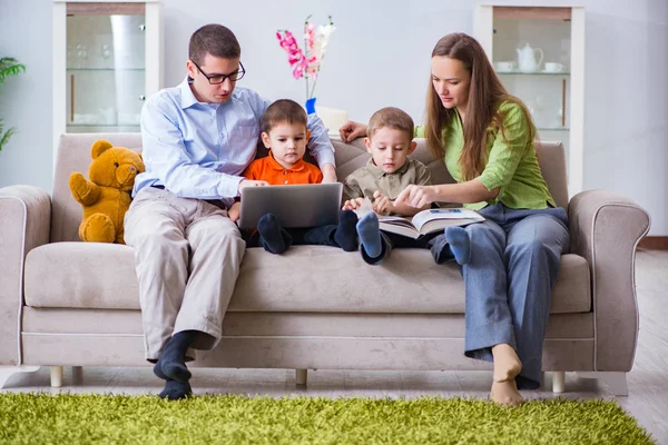Young family surfing internet and looking at photos — Stock Photo, Image