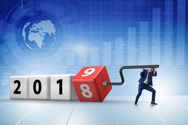 Businessman employee rotating cube to reveal number 2019 — Stock Photo, Image