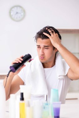 Tuvaletteki genç yakışıklı adam hijyen konseptinde. 