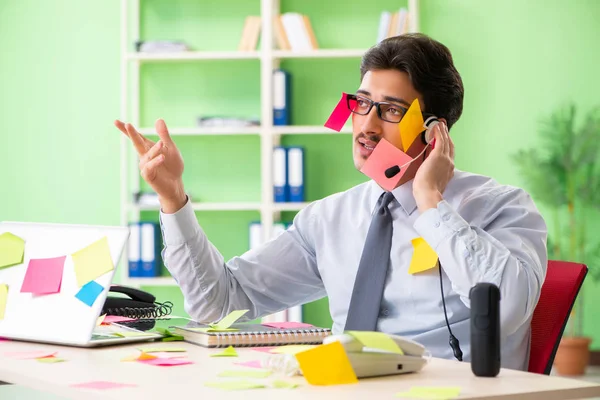 Young help desk operator working in office with many conflicting — Stock Photo, Image