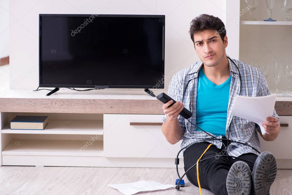 Man trying to fix broken tv