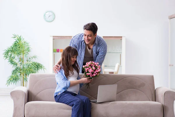 Happy family celebrating pregnancy at home