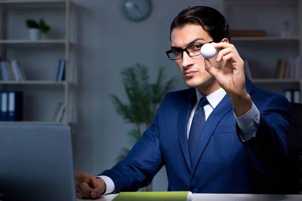 Young employee with golf ball in office — Stock Photo, Image