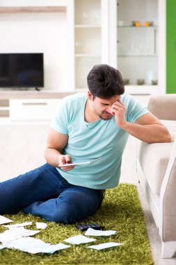 Genç adam kişisel finans ve faturalarla boğuşuyor.