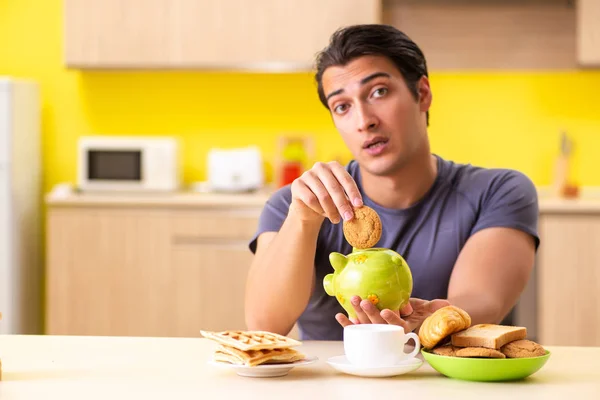 Young man in unhealthy food concept — Stock Photo, Image