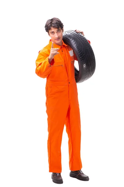 Young garage worker with tyre isolated on white — Stock Photo, Image