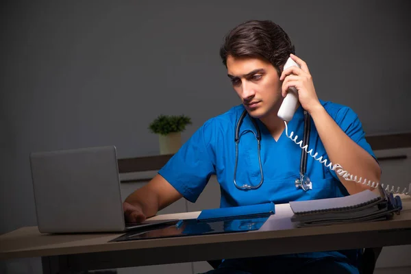 Young handsome doctor working night shift in hospital — Stock Photo, Image