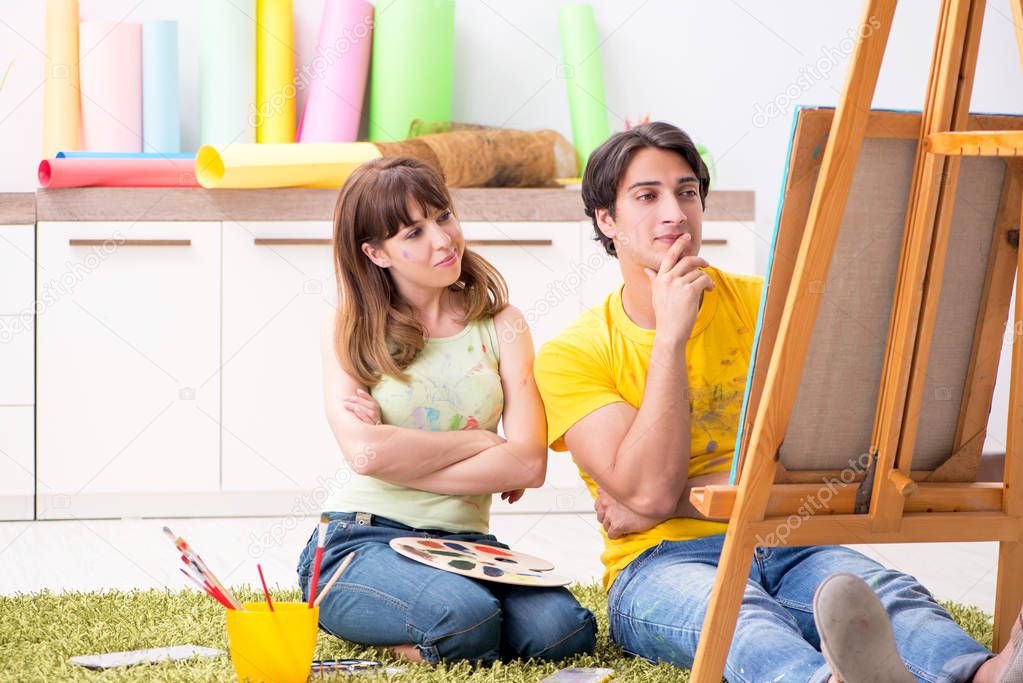 Young couple enjoying painting at home