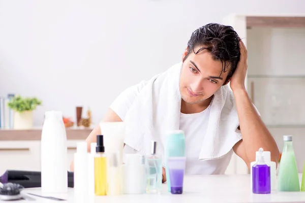 Young handsome man in the bathroom in hygiene concept — Stock Photo, Image