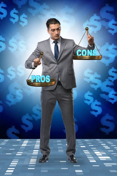 Businessman choosing pros and cons — Stock Photo, Image