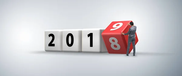 Businessman employee rotating cube to reveal number 2019 — Stock Photo, Image