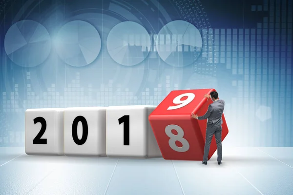 Businessman employee rotating cube to reveal number 2019