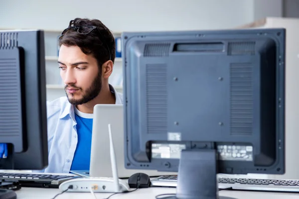 IT technician looking at IT equipment