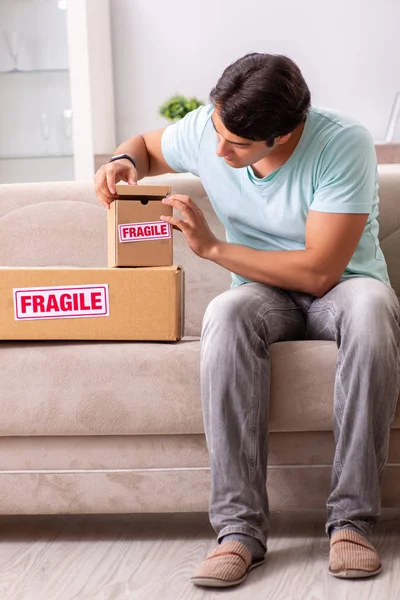 Mann öffnet fragiles Paket, das im Internet bestellt wurde — Stockfoto