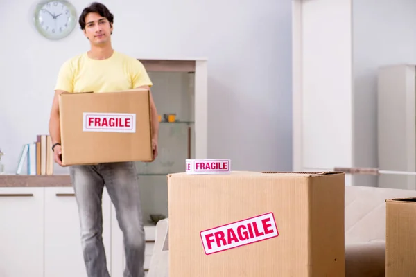 Man moving house and relocating with fragile items — Stock Photo, Image