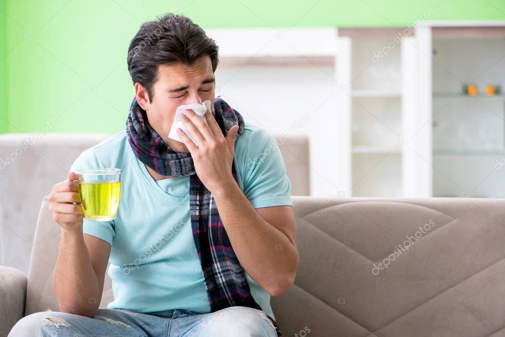 Young handsome man suffering from illness at home 