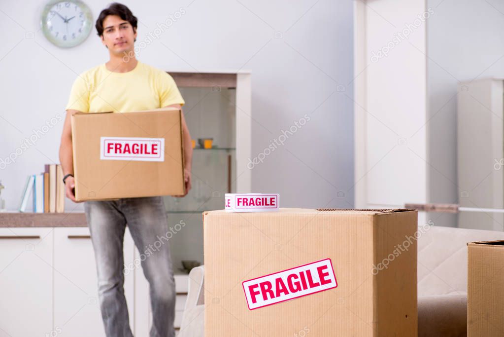 Man moving house and relocating with fragile items