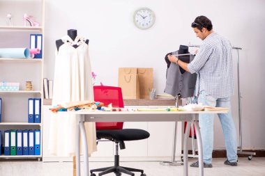 Atölyesinde çalışan yakışıklı bir terzi.