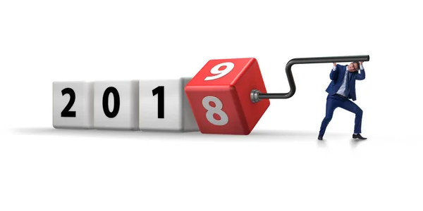 Businessman employee rotating cube to reveal number 2019