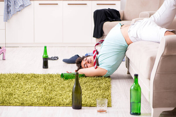 Young drunk handsome man after party at home 