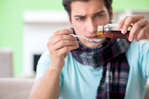 Young handsome man suffering from illness at home — Stock Photo, Image