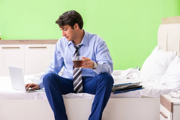 Businessman working overtime in hotel room