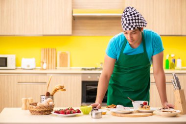 Genç profesyonel aşçı mutfakta hazırlanıyor.