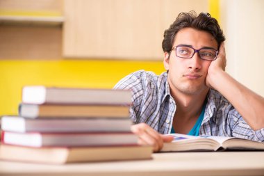 Sınava hazırlanan öğrenci mutfakta oturuyor. 