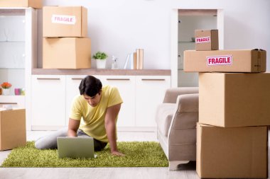 Man moving house and relocating with fragile items clipart