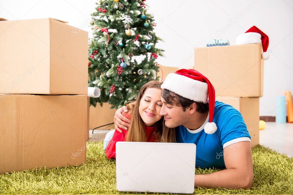 Young family celebrating christmas in new home