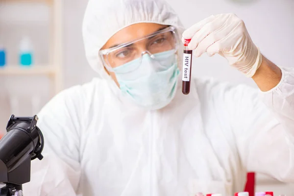 Asistente de laboratorio joven guapo analizando muestras de sangre en el hospital — Foto de Stock