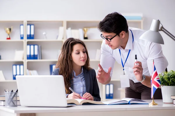 Teacher explaining to student at language training