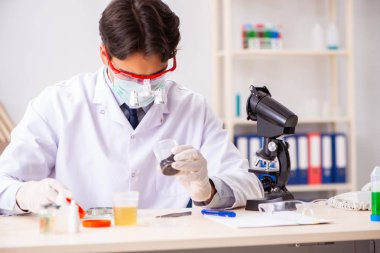 Laboratuvarda çalışan yakışıklı bir kimyager.