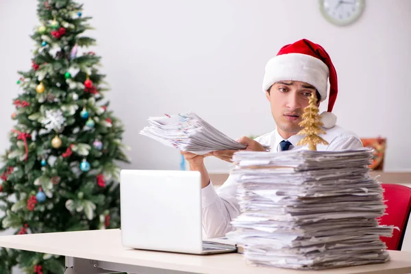 Jeune travailleur travaillant au bureau pendant le quart de Noël — Photo