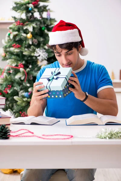 Young student with book at Christmas eve — Stock Photo, Image