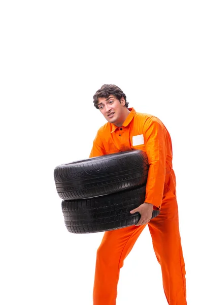 Young garage worker with tyre isolated on white — Stock Photo, Image