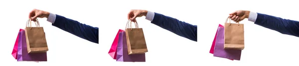 Hand holding shopping bags with christmas shopping on white back — Stock Photo, Image