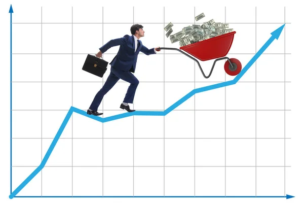 Empresário empurrando carrinho de mão cheio de dinheiro dólar — Fotografia de Stock