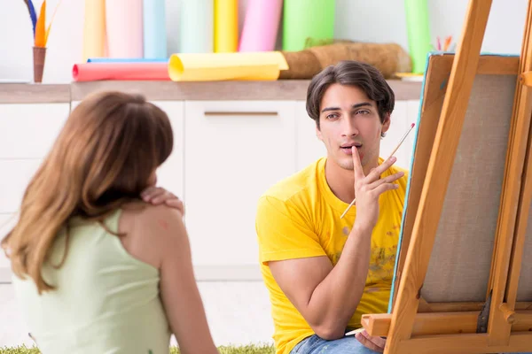 Jovem casal curtindo pintura em casa — Fotografia de Stock