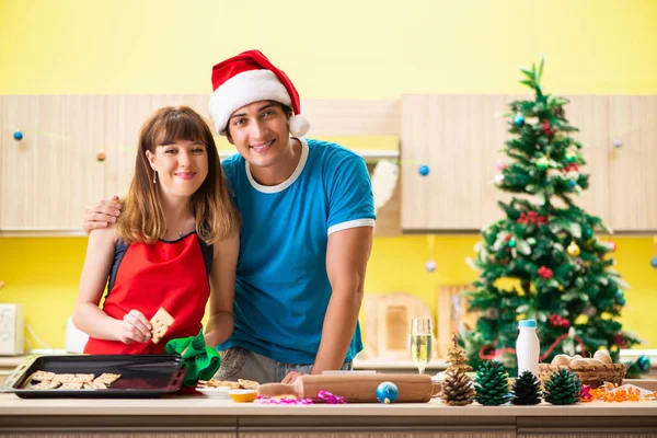 Young couple celebrating Christmas in kitchen — Stock Photo, Image