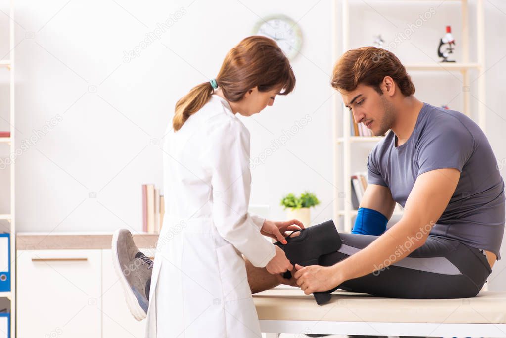 Young male patient visiting female doctor traumatologist 