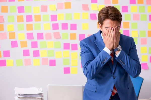 Junger schöner Mann in widersprüchlichem Prioritätenkonzept — Stockfoto