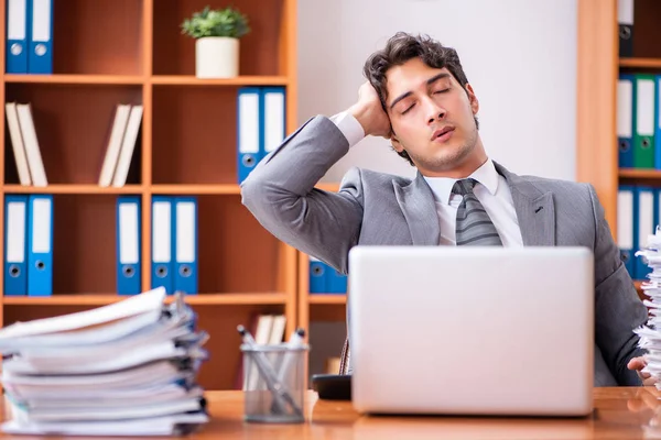 Young handsome businessman unhappy with excessive work — Stock Photo, Image