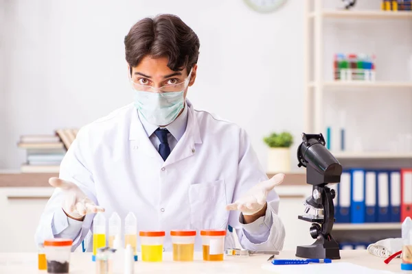 Giovane bel chimico che lavora in laboratorio — Foto Stock