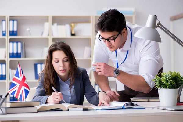 Teacher explaining to student at language training — Stock Photo, Image