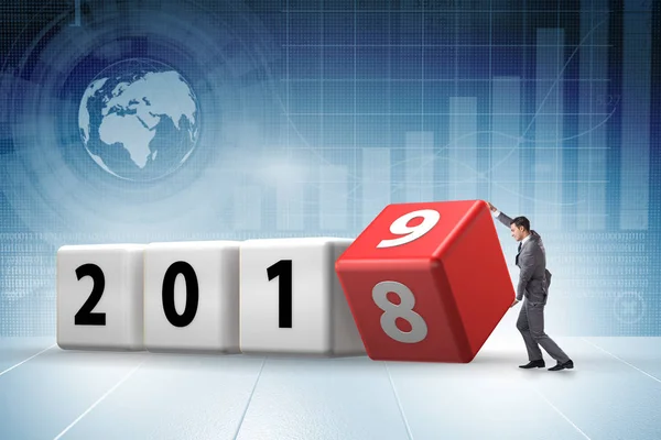 Businessman employee rotating cube to reveal number 2019